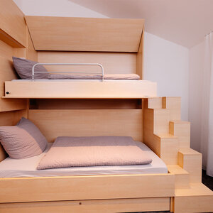 Image of a wooden double bed from the side