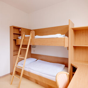 Image of a wooden double bed from the side