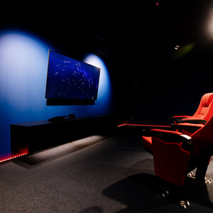 Image of two red gaming chairs in front of a monitor 