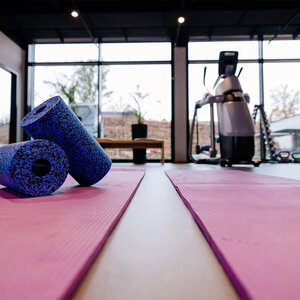 Abbildung eines verschiedener Fitnessgeräte und Yoga-Matten