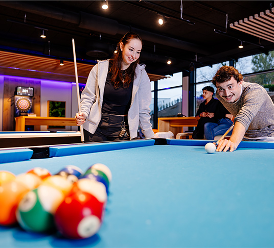 Picture of a group of young people playing pool